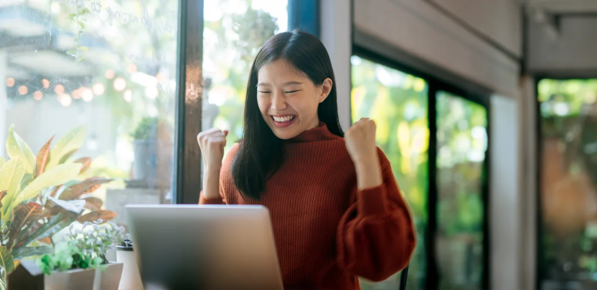 Student attending to an online class wearing a brown sweater