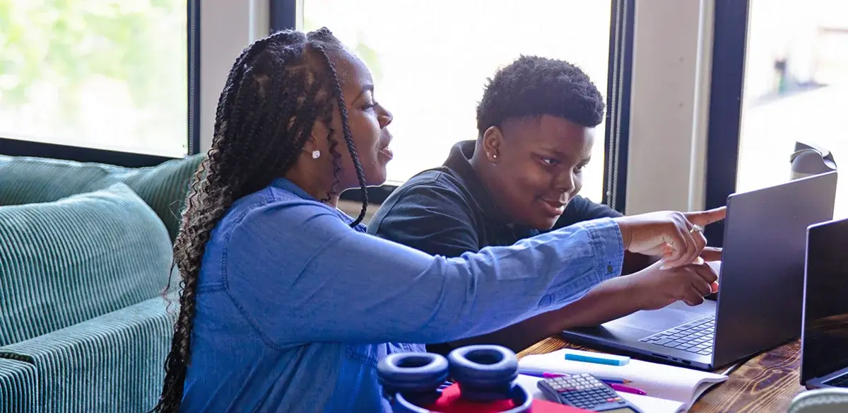 Mother and son working together with their laptop