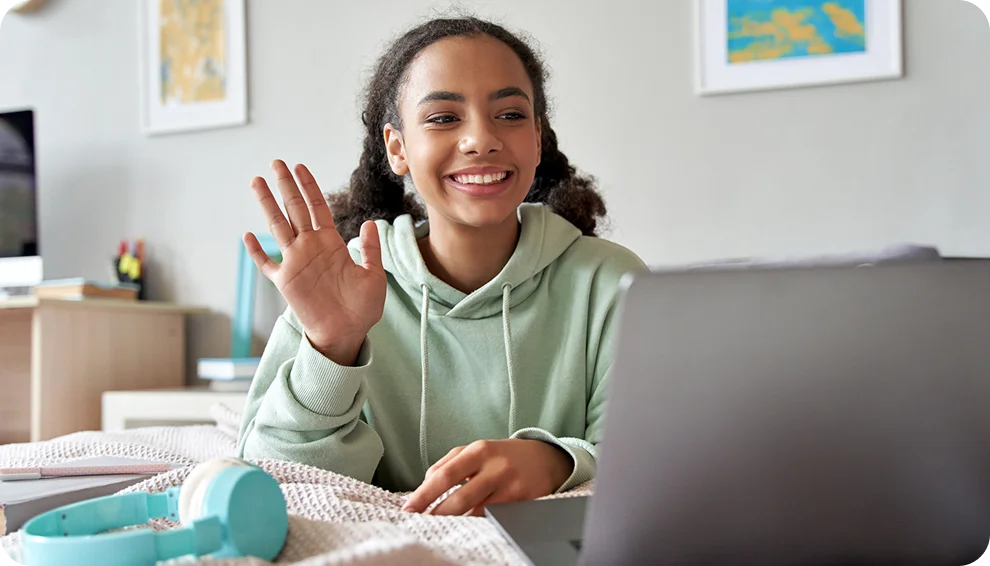 Student attending to an online class wearing a light green hoodie